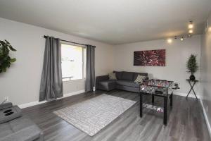 a living room with a couch and a window at Entire Citrus House in Fresno in Fresno