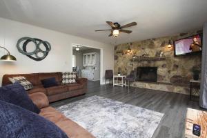 a living room with a couch and a fireplace at Entire Citrus House in Fresno in Fresno