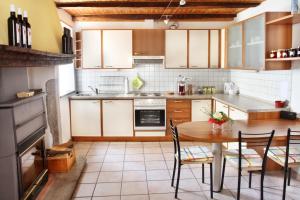 a kitchen with a table and chairs in it at Ca' di Pincia in Astano