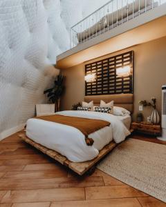 a bedroom with a large bed on a wooden platform at Ona Geo Dome At El Mstico in Nogal
