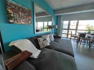 a living room with a couch and a table at Atlantis Spacious Loft-Sea view in San Juan