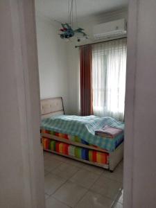 a bedroom with a bed and a window at House in Grand Wisata Bekasi in Cibuntu