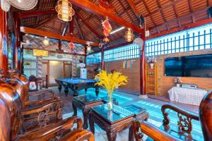 a room with two ping pong tables and chairs at Ngọc Thị Villa in Vung Tau