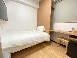 Postel nebo postele na pokoji v ubytování 宏洲旅社HZ Hotel