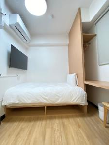 Postel nebo postele na pokoji v ubytování 宏洲旅社HZ Hotel