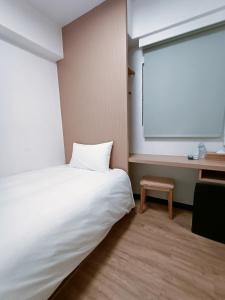 Postel nebo postele na pokoji v ubytování 宏洲旅社HZ Hotel