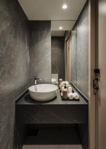 a bathroom with a large white sink on a counter at The Bus Collective in Singapore