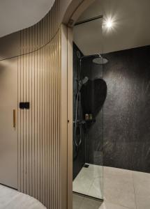 a bathroom with a shower with a glass door at The Bus Collective in Singapore