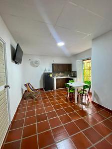 アグアチカにあるApartaestudio Villa Mary-Aguachicaのタイルフロアのキッチン(テーブル、椅子付)