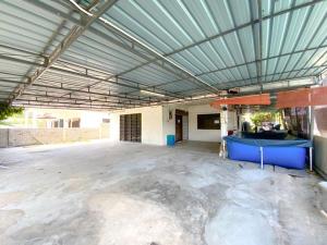 an empty parking lot with a large metal ceiling at Family's Homestay in Kuala Terengganu