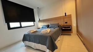 a bedroom with a bed with two towels on it at Remanso de Mar in Mar del Plata