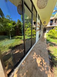 a hallway of a house with large windows at Casa Delia Hotel Downtown in Bacalar