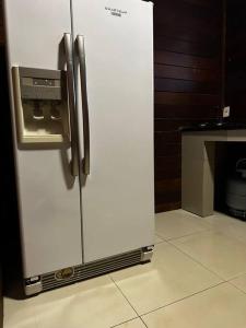 a refrigerator with a dispenser on it in a kitchen at Casa Monte Verde in Petrópolis