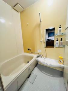 a bathroom with a tub and a sink at Yuyu House Kohama Teru - Vacation STAY 15334 in Osaka