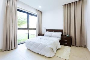 a bedroom with a large bed and a large window at Incredible 2 Bedroom Space Available in Accra