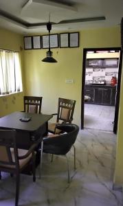 uma sala de jantar com uma mesa e cadeiras num quarto em RK GUEST HOUSE em Bodh Gaya