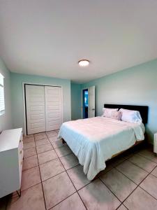 a bedroom with a large bed and a white door at Water Front House in Providenciales