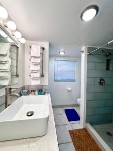 a bathroom with a large white tub and a shower at Water Front House in Providenciales