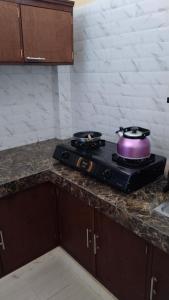 a purple pot sitting on top of a stove in a kitchen at D'Natha Villa Ubud in Ubud