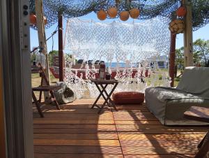 a screened in porch with a view of a fountain at El Navegante in Cabo Polonio