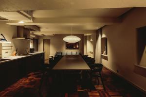 a dining room with a long table and chairs at THE KNOT TOKYO Shinjuku in Tokyo