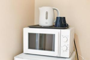 a white microwave with a blender on top of it at Edogawa Japanese Style Apartment 201 has direct access to Akihabara and Shinjuku, with convenient transportation and free WiFi in Tokyo
