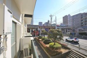 a balcony of a building with a car on the street at Edogawa Japanese Style Apartment 201 has direct access to Akihabara and Shinjuku, with convenient transportation and free WiFi in Tokyo