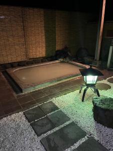 a bath tub with a light in front of it at Fuji-Hakone Guest House in Hakone
