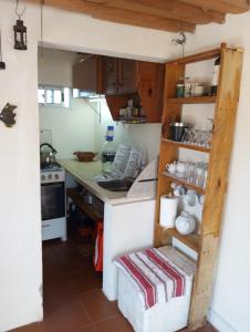 a small kitchen with a counter and a stove at El Navegante in Cabo Polonio