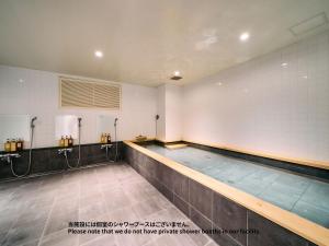 an empty swimming pool in a gymnasium at Hotel Plus Hostel TOKYO ASAKUSA 1 in Tokyo