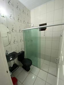 a small bathroom with a toilet and a sink at Casa praia alcobaca 3 quartos in Alcobaça