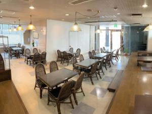 uma sala de jantar com mesas e cadeiras num restaurante em Hotel Alpha-One Takaoka em Takaoka