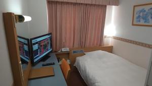 Postel nebo postele na pokoji v ubytování Hotel Alpha-One Tsuruga