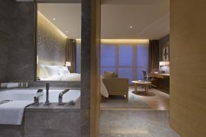 a hotel room with a bath tub and a bed at The Westin Chongqing Liberation Square in Chongqing +83 photos