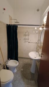 a bathroom with two sinks and a toilet and a shower at Hostería Suites Del Centro in Santa Rosa de Calamuchita