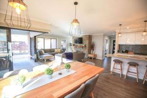 a kitchen and living room with a table and chairs at Amaroo in Bright