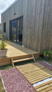 a wooden deck in front of a building at Le p’tit tram in Cancale +11 photos