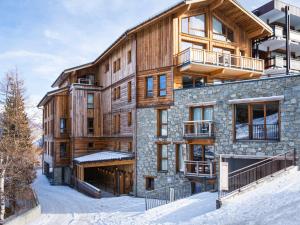 a large wooden building in the snow at Appartement Courchevel 1650, 3 pièces, 8 personnes - FR-1-618-32 in Courchevel