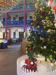 a christmas tree with presents under it in a building at Wenjun Courtyard Hotel ---5 mins walk from Tonghuimen metro station, near Tianfu square, close by culture park and Sichuan opera house, English speaking service, local tours in Chengdu