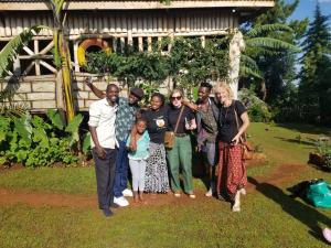 a group of people posing for a picture in front of a house at Rock garden Sipi in Kapchorwa