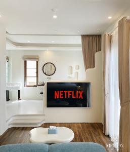 a living room with a netflix sign on the wall at Mellon OASIS Phu Quoc in Phú Quốc