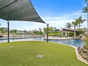 a swimming pool at a resort with a lawn at Yarrawonga Lakeside Apartment 38 in Mulwala +7 photos