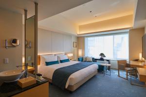 a hotel room with a bed and a sink at THE KITANO HOTEL TOKYO in Tokyo