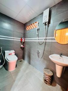 uma casa de banho com um chuveiro, um WC e um lavatório. em Việt Kiều Royal em Xuyên Mộc