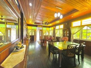 a dining room with a table and chairs at Tamteh Homestay in Ayer Hitam