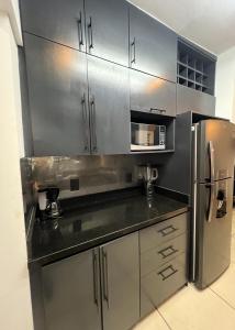 a kitchen with silver cabinets and a stainless steel refrigerator at Casa valle oriente in Saltillo