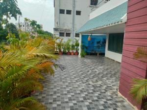 a courtyard of a house with plants and a building at INDEPENDENT PEACE FULL GUAST HOUSE in Tanuku