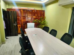 a conference room with a long table and chairs at INDEPENDENT PEACE FULL GUAST HOUSE in Tanuku