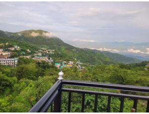 uma vista para a cidade a partir de uma varanda em The Mountain Paradise Hotel, Rewalsar, H.P. em Mandi