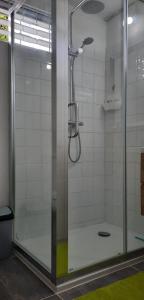 a shower with a glass door in a bathroom at Breezy La Vista on the Terrace in Saint James